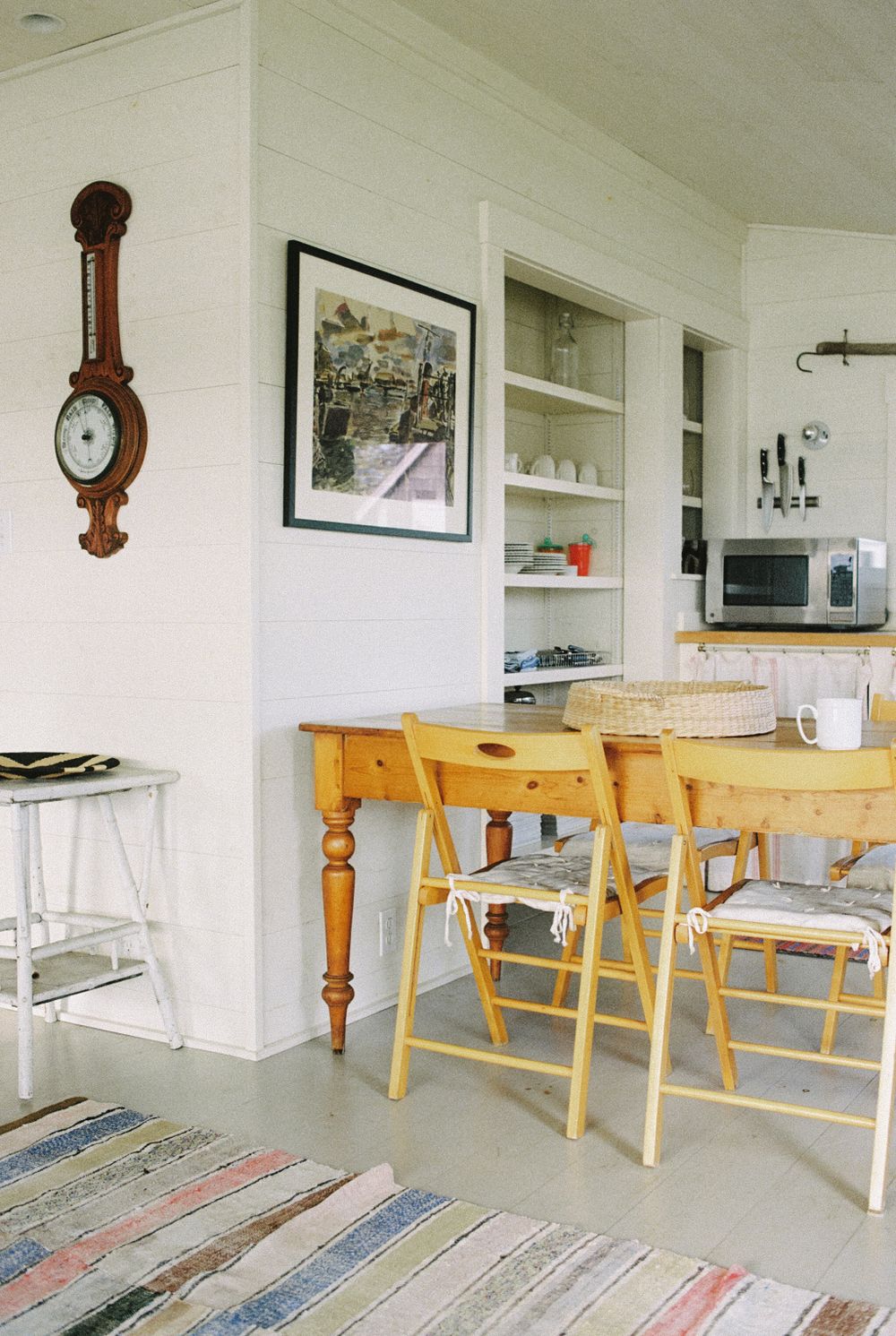 The kitchen and table and chairs in the guest house at Harbor Cottage in Rockland, Maine.