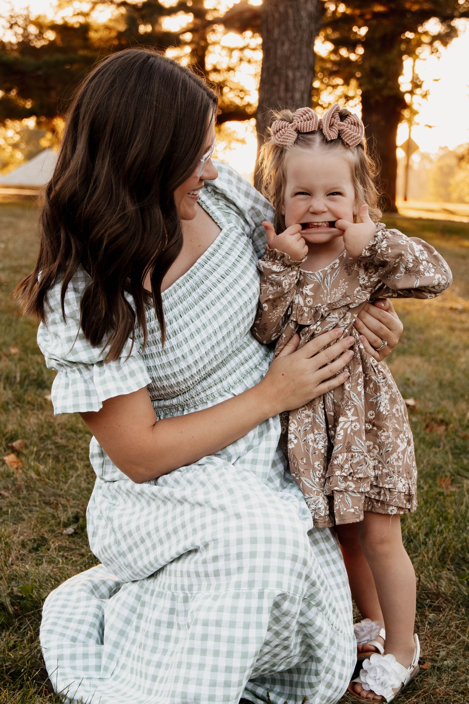 A joyful moment shared between two people in a sunny outdoor setting during golden hour.