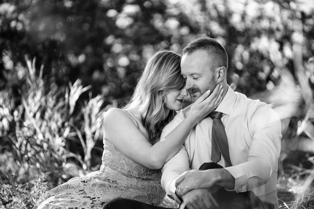 Black and white romantic portrait series of couple sharing intimate moments outdoors.
