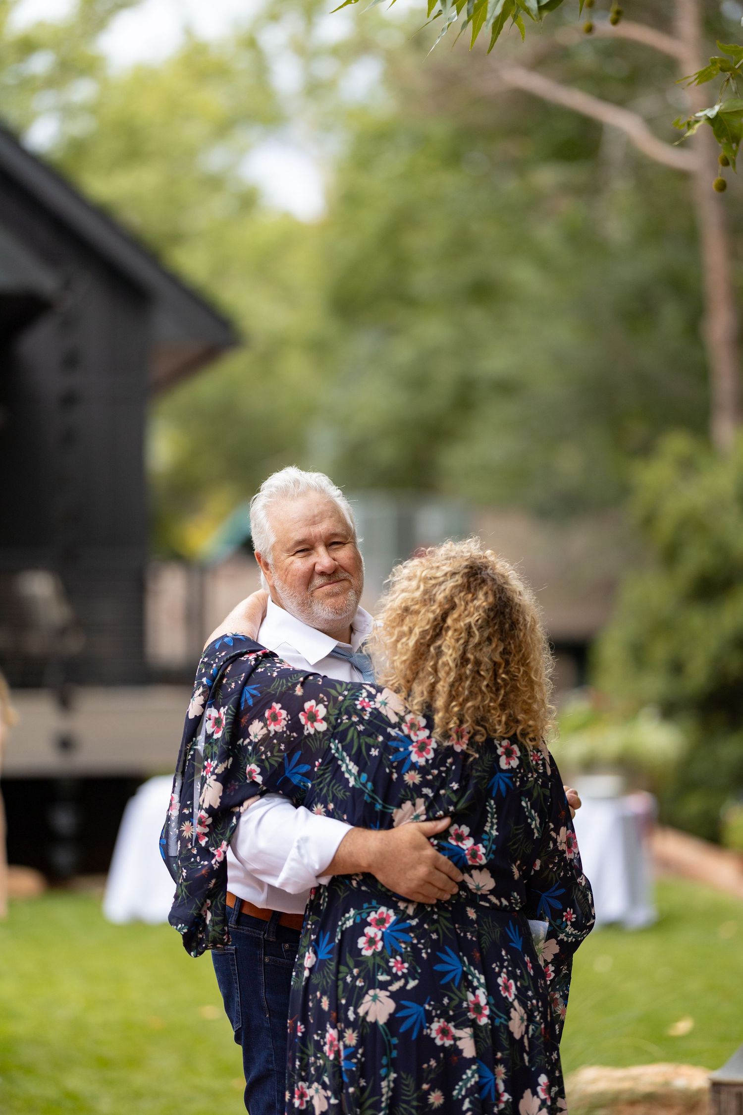 A couple shares a dance together at an outdoor event.