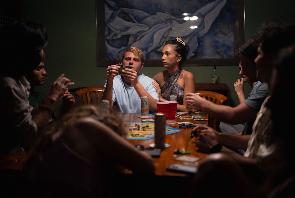 Friends sharing laughs and conversation during a casual game night.