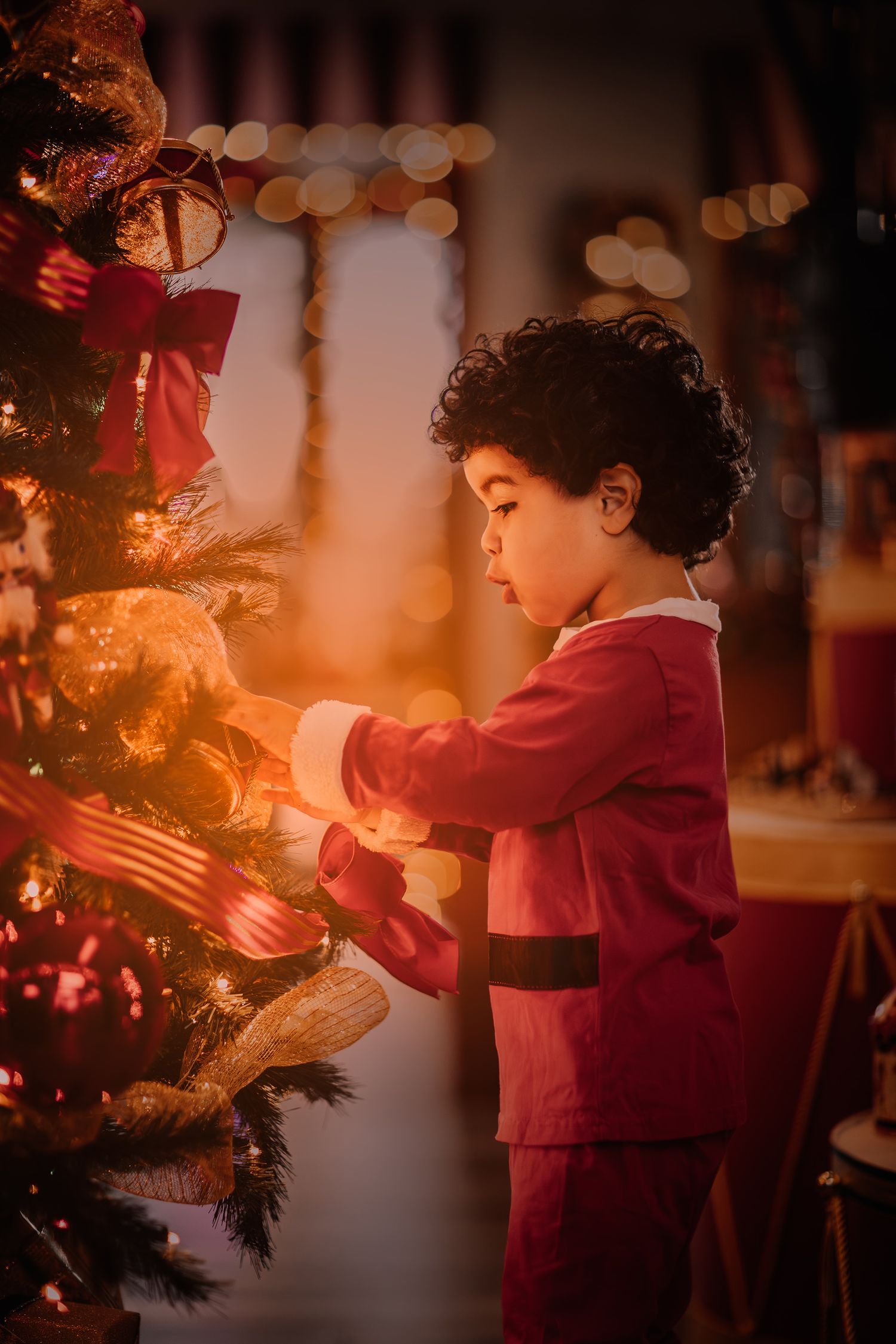 Shelves filled with colorful Christmas ribbons and decorative trims in red, green, and festive patterns.