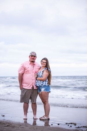 Couple enjoying a moment together at the ocean's edge.