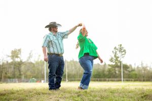 Playful outdoor photography sequence showing couple walking through sunny field.