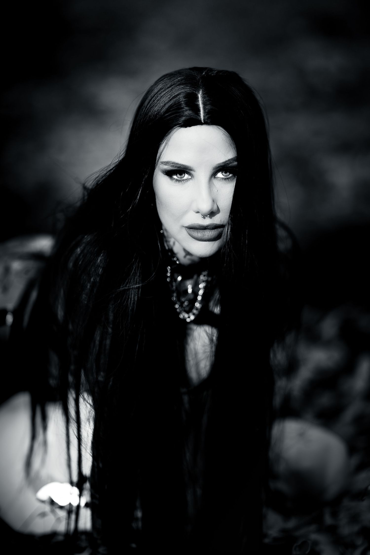 Dark gothic style portraits with dramatic black and white lighting effects create a moody atmospheric aesthetic.