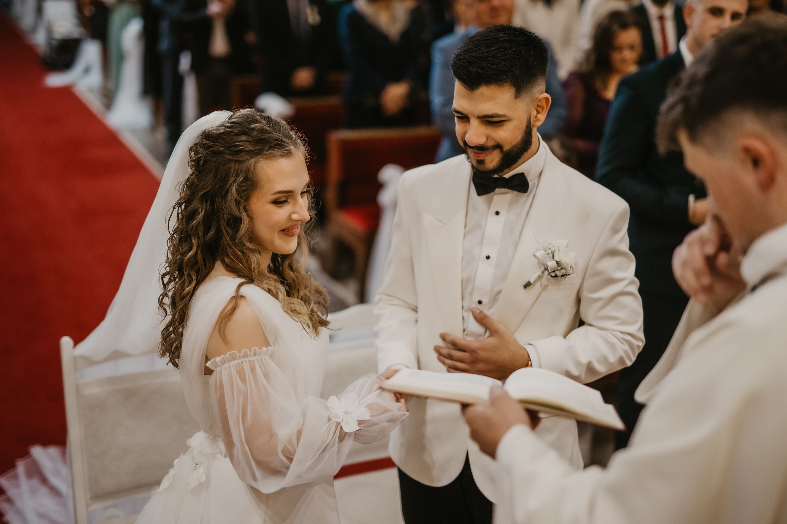 A couple exchanges vows during their traditional Catholic wedding ceremony.