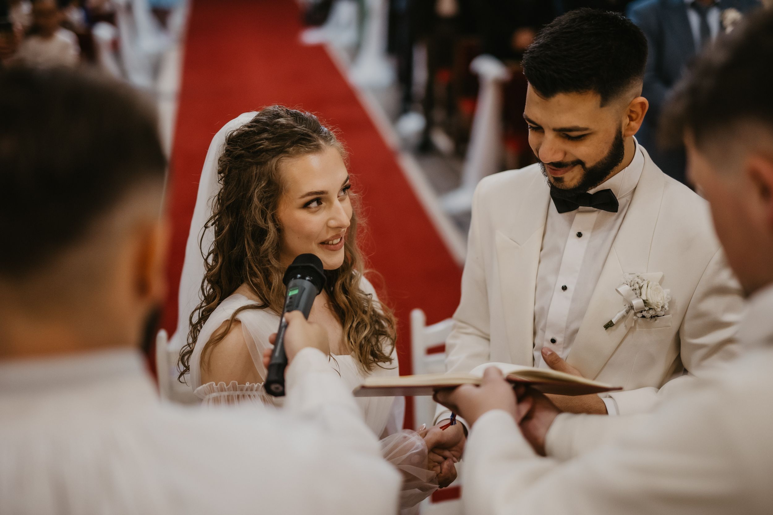 A bride and groom share a moment during their wedding ceremony in church.