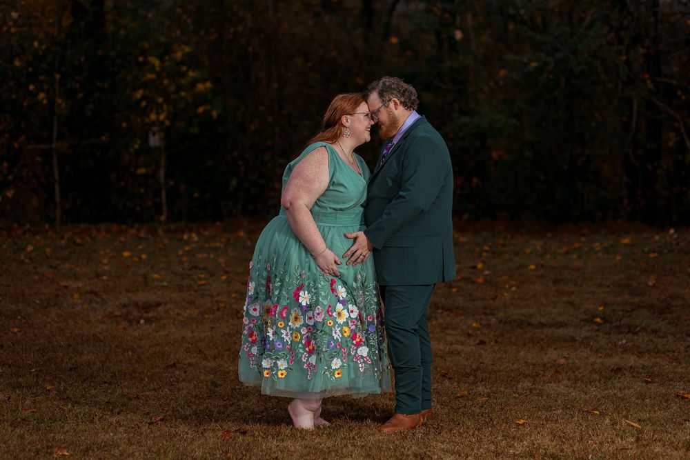 Romantic maternity portrait of a couple embracing at dusk during an outdoor session in Greenville, SC.