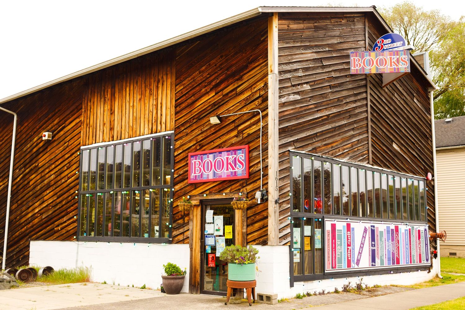 Rustic wooden bookstore exterior with large windows and vintage signage.
