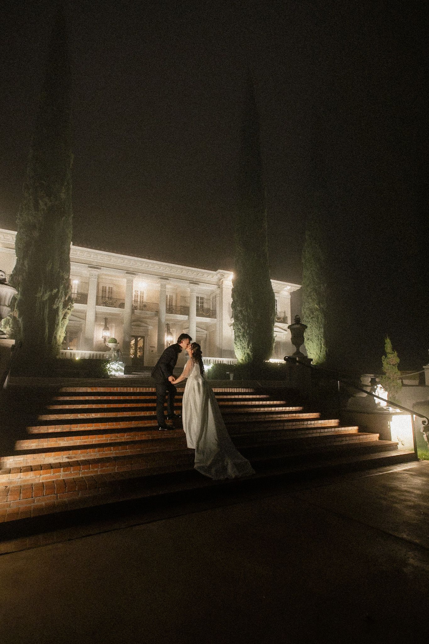 Romantic engagement photo with joyful couple sharing intimate moment outdoors.