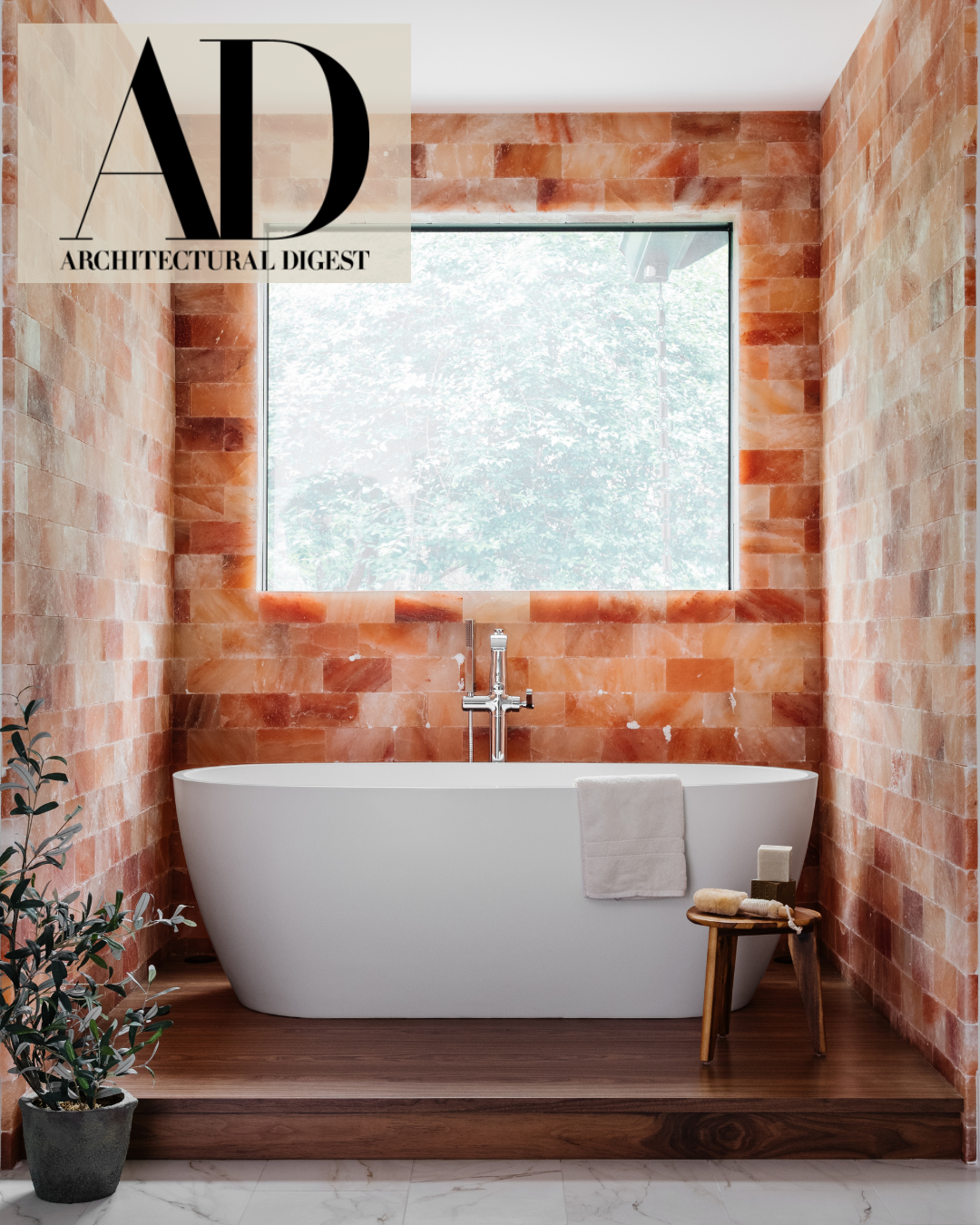 Primary bathroom with tub and walls around it tiled in pink salt tiles.