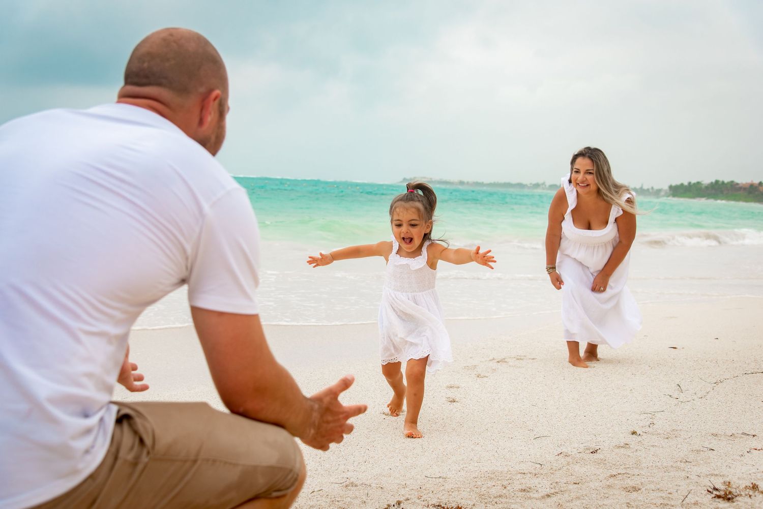 Family playing and having fun during their beach photo session in Akumal, Mexico