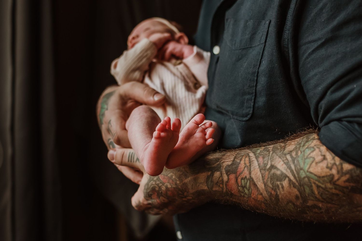 dad holding newborn baby