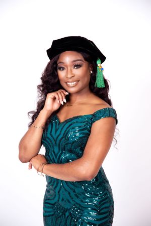 Graduation portraits in sparkling teal dress and cap with green tassel against white backdrop.