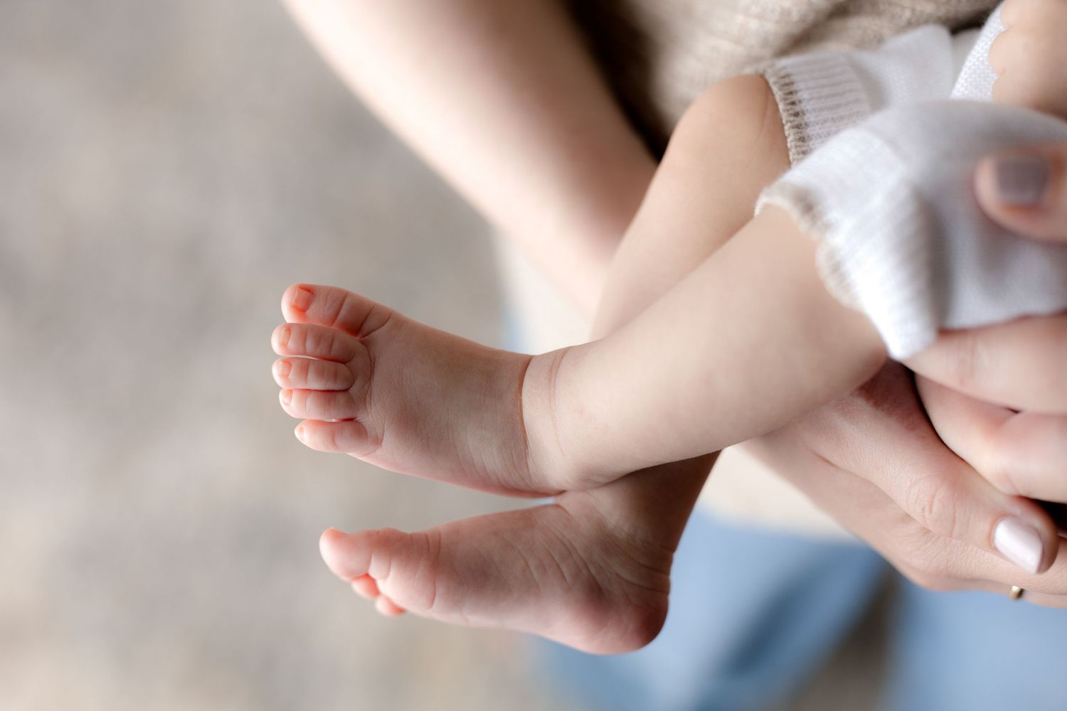 Close up detail shot of baby feet during indoor photo session.