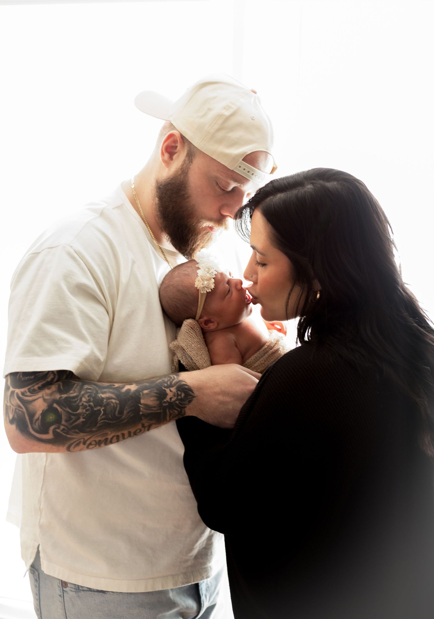 Intimate black and white family portrait series against white background.