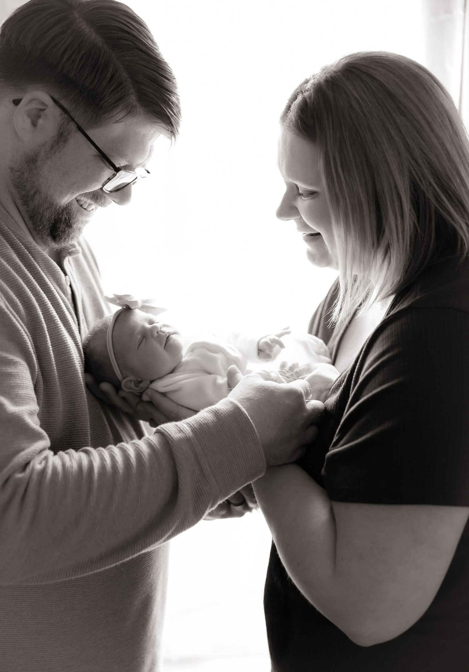 Intimate black and white portraits of couple sharing tender moments.