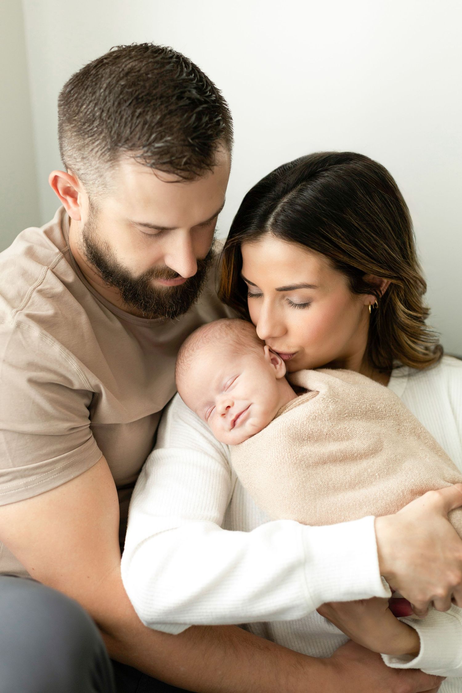 Tender family portrait series in soft neutral tones.