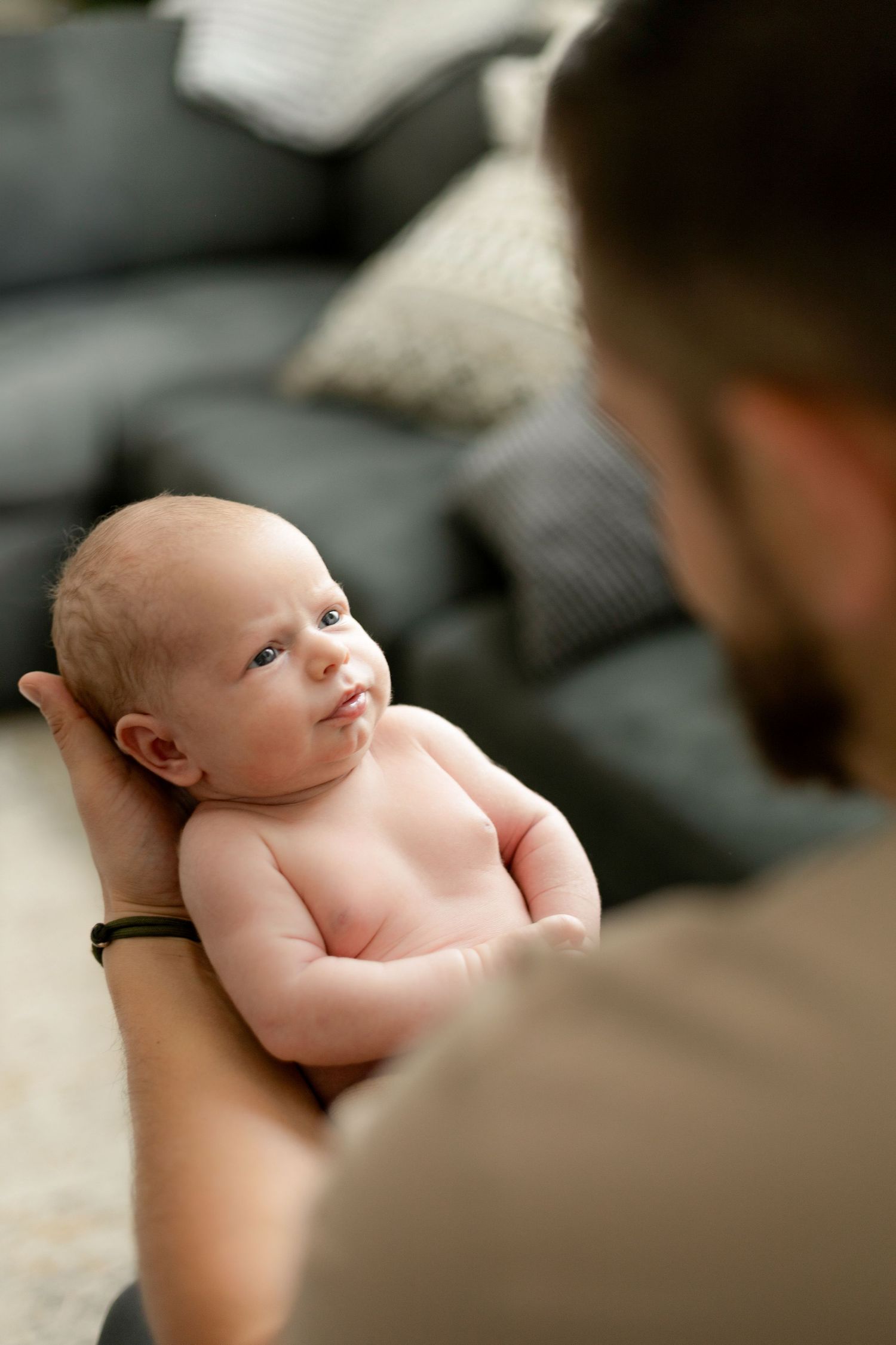 Baby lying on back during intimate portrait session.
