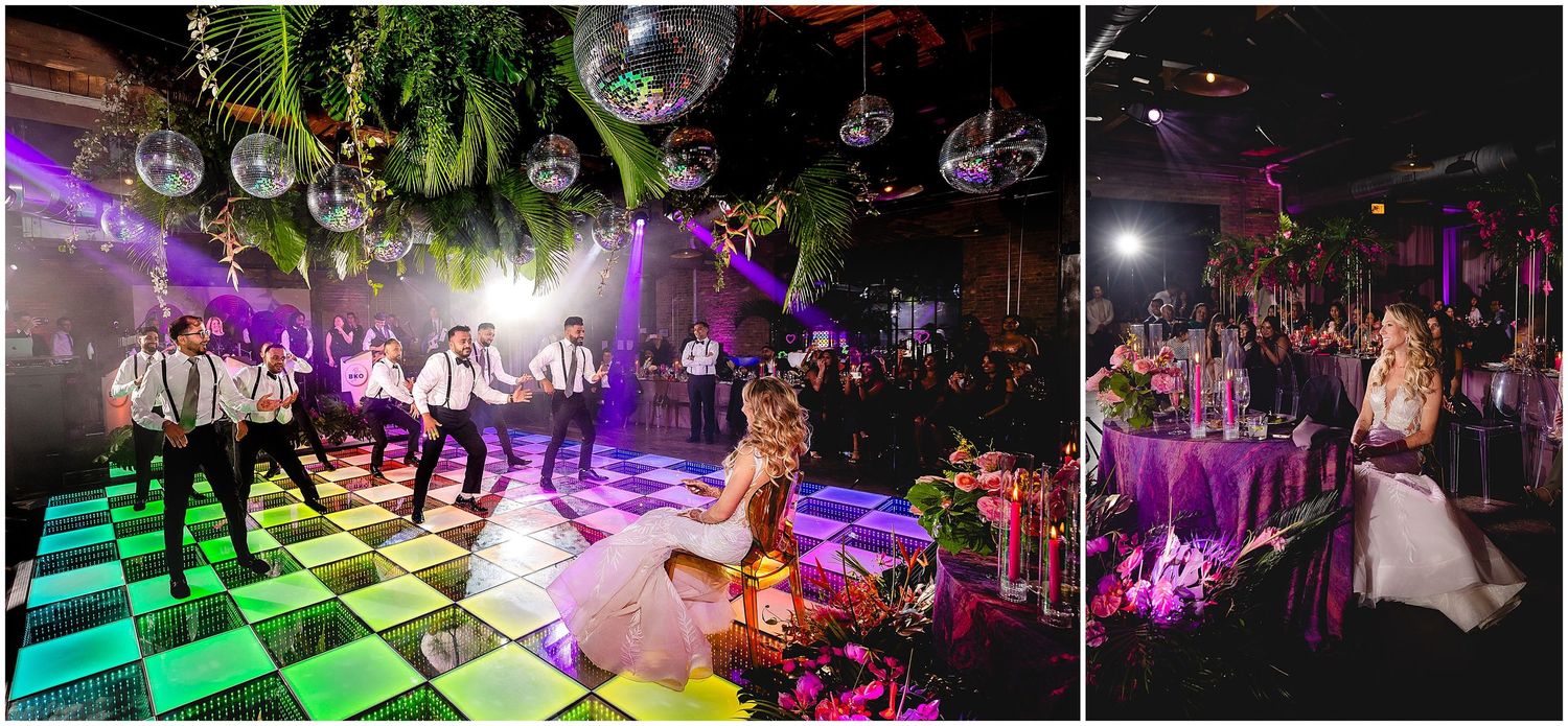 Dance floor illuminated with purple and green lights under disco balls at a wedding reception celebration.