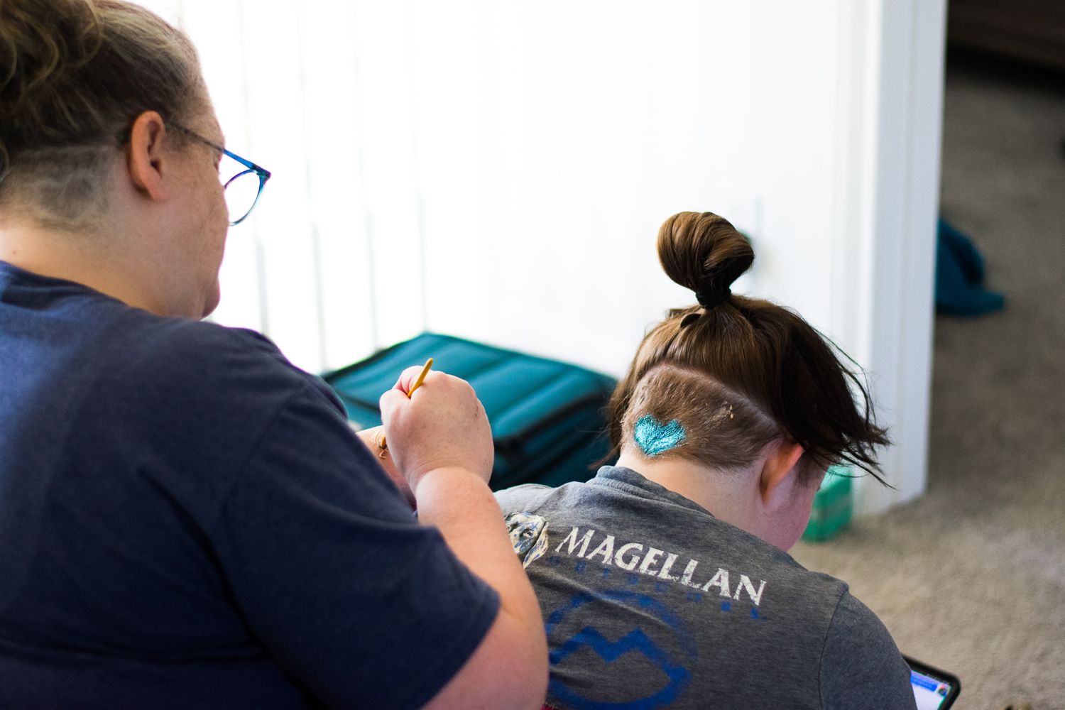 Close-up of someone wearing a Magellan shirt getting ready for an event.
