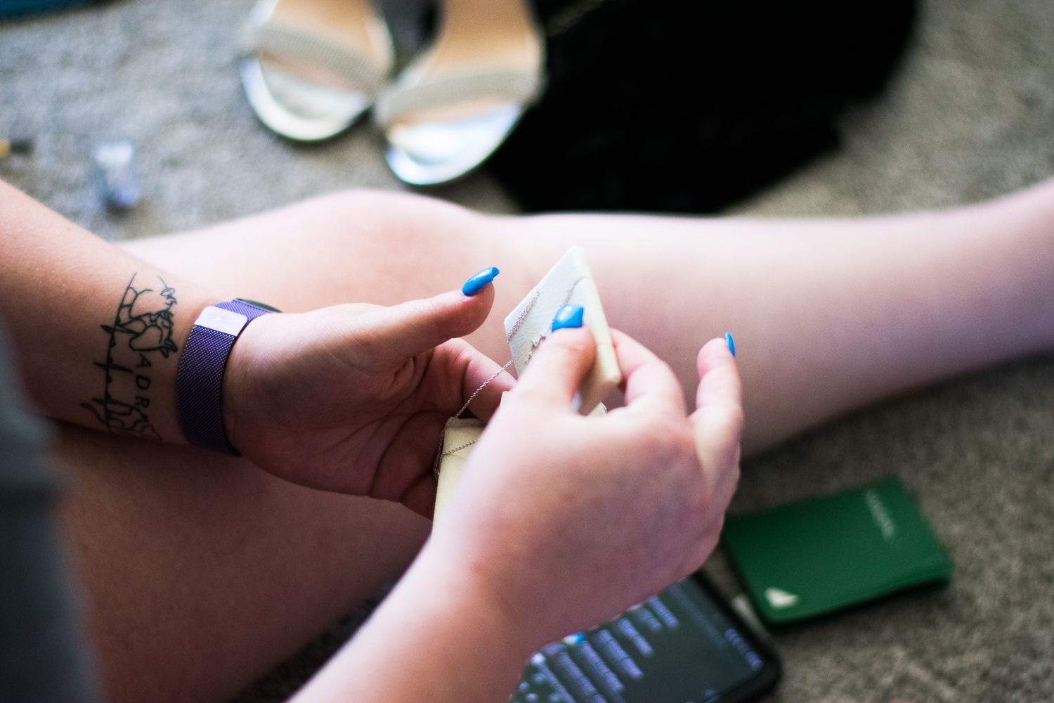 Close-up of hands applying temporary tattoos or decorations.