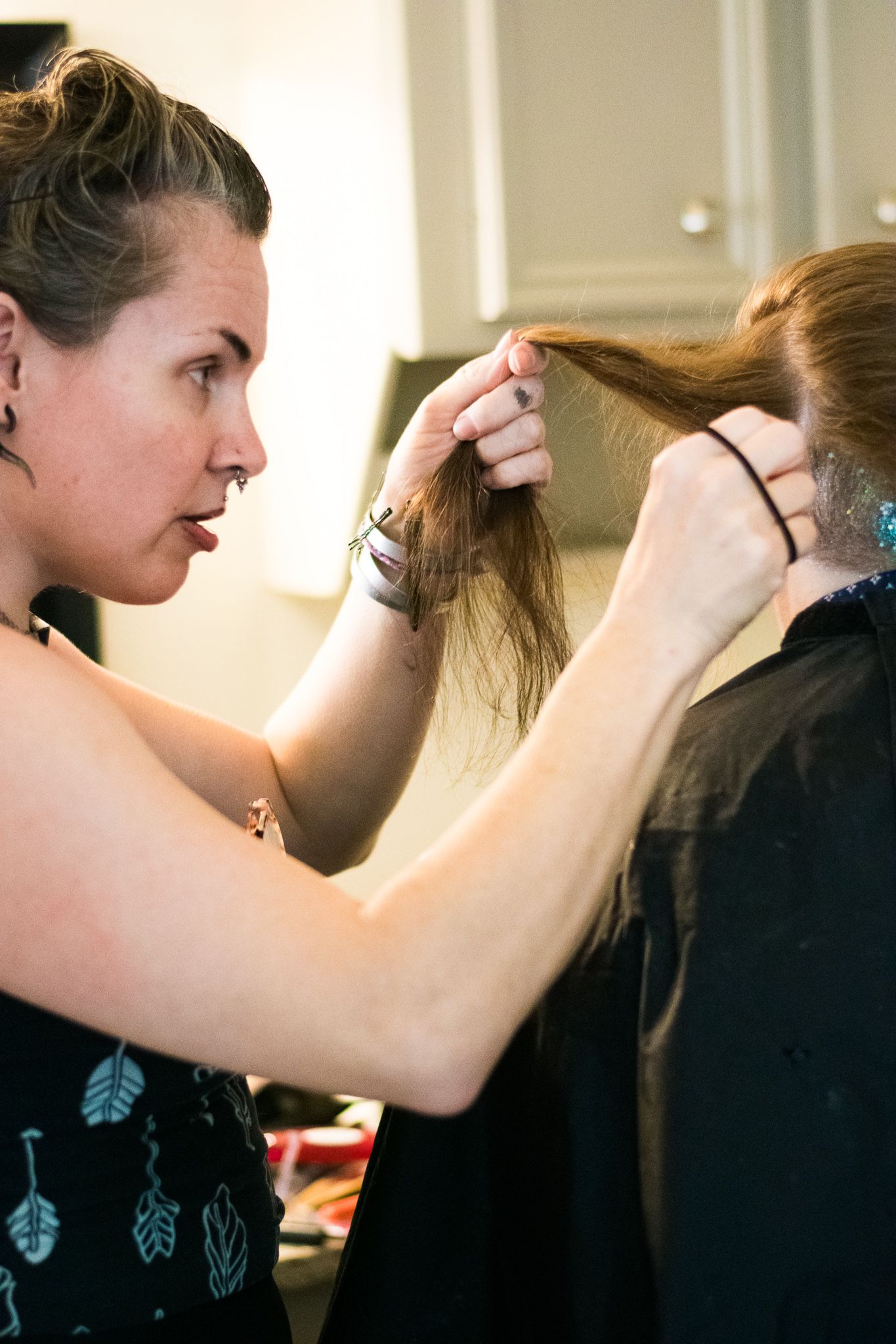Someone styling hair while getting ready for a special event.