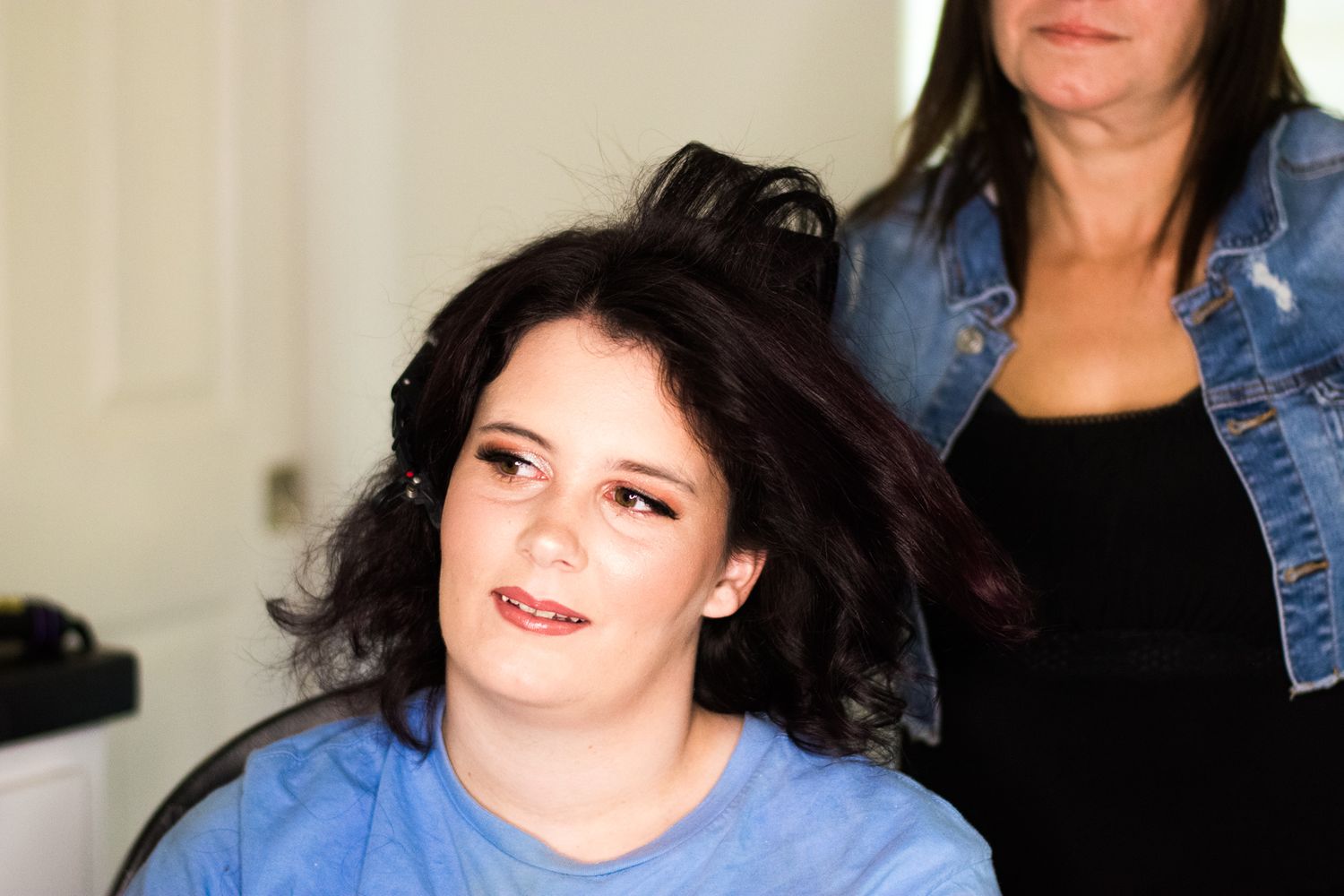 Hair styling session in progress at a beauty salon.