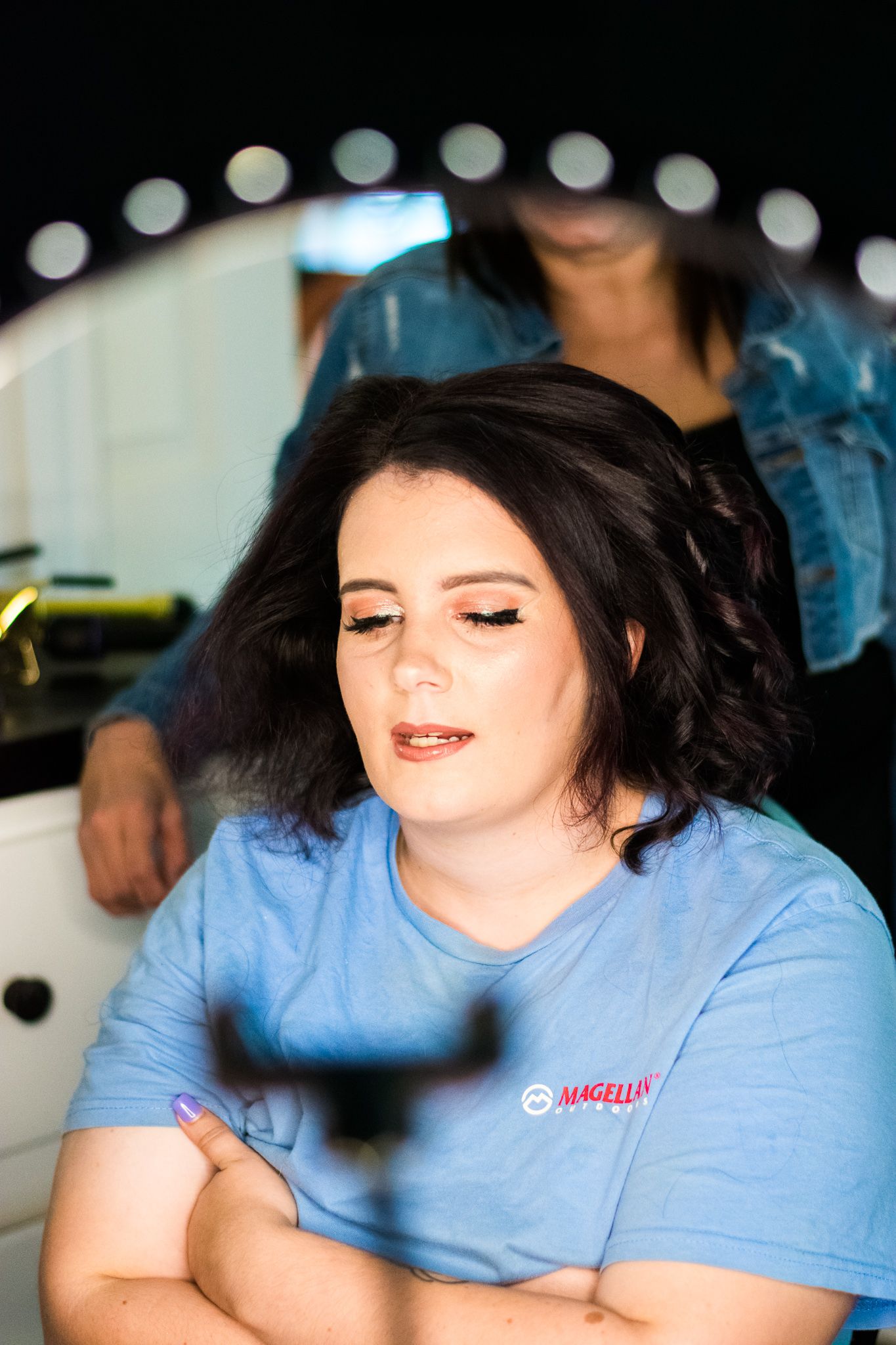 Finished hairstyle with soft curls and natural makeup for special event.