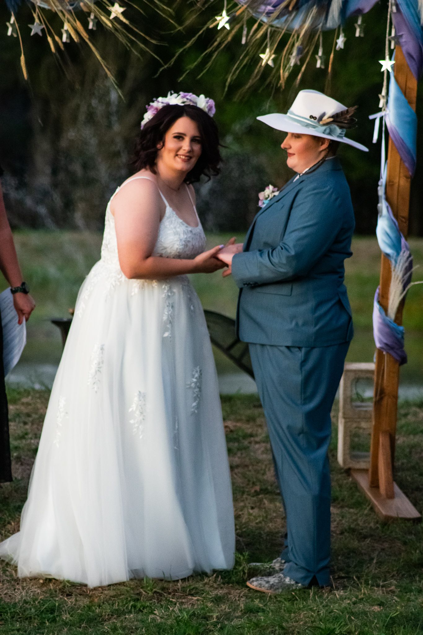 Joyful moment between two people during an outdoor wedding ceremony.