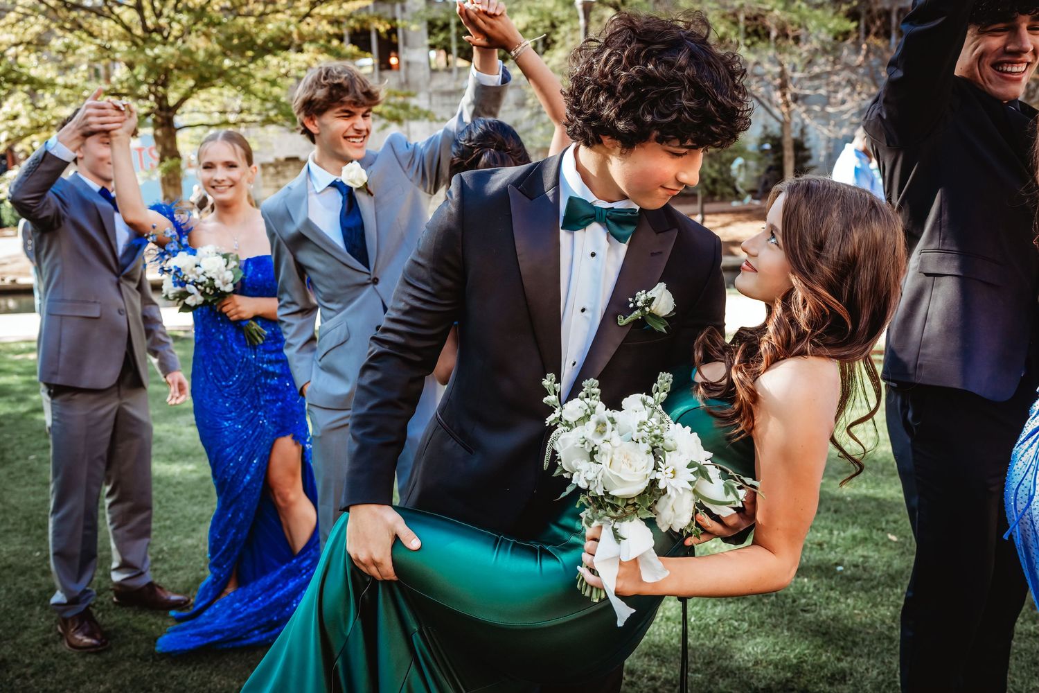 Wedding party celebrates with laughter and joy during outdoor ceremony.