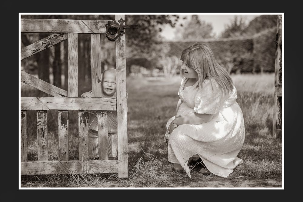Black and white photo of a family spending quality time outdoors on a sunny afternoon.