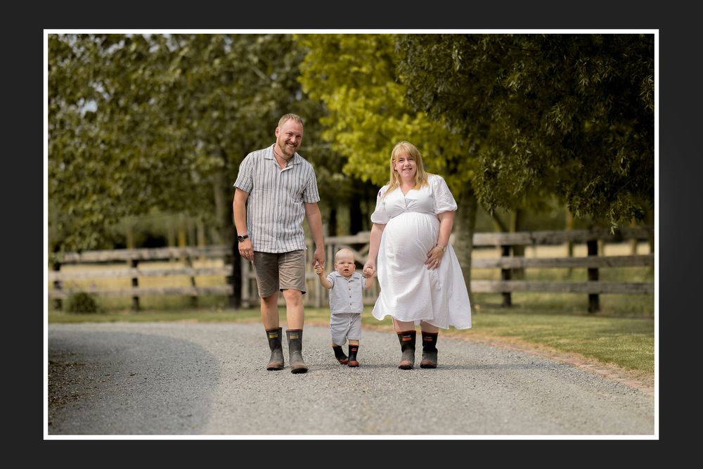 A series of engagement photos showing a couple walking and posing together on a tree-lined path in a park.