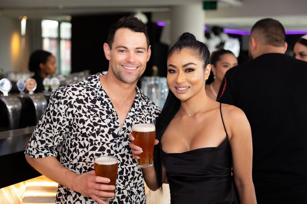 Sydney Event Photography - Two people enjoying drinks at a Cargo bar, with one wearing an animal print shirt.