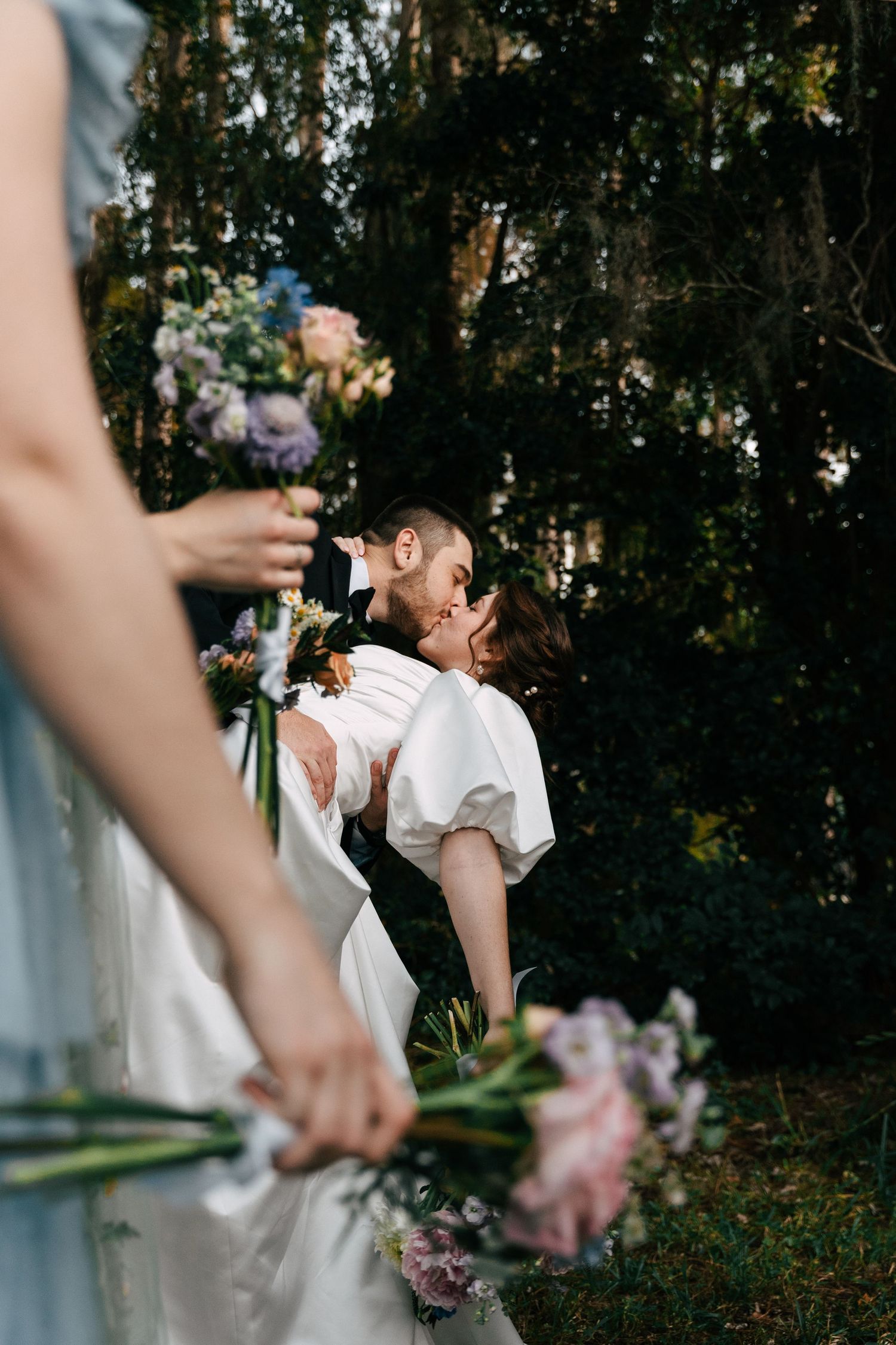photo of the groom dipping the bride while kissing her after she said yes