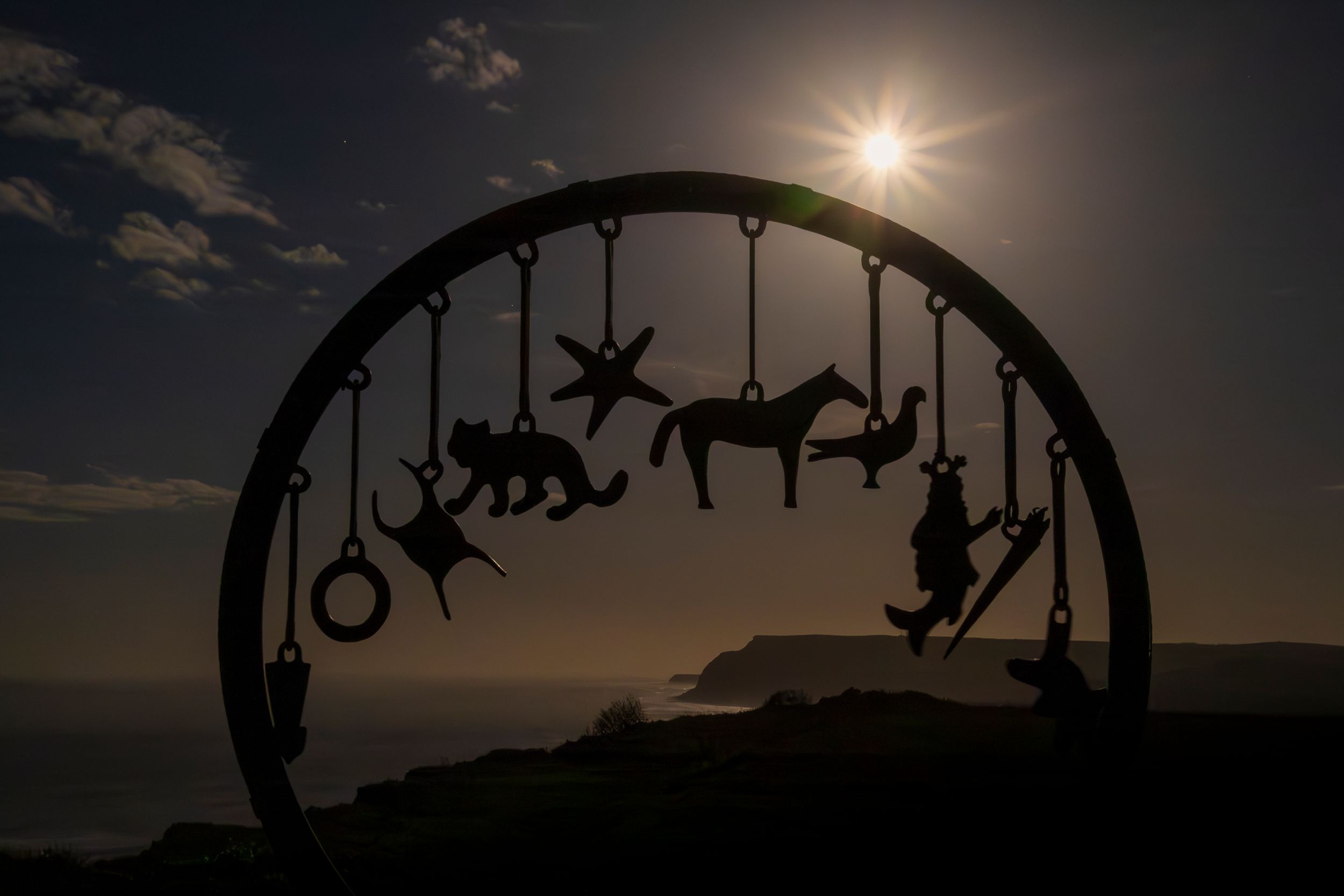 Charm Bracelet sculpture under moonlight