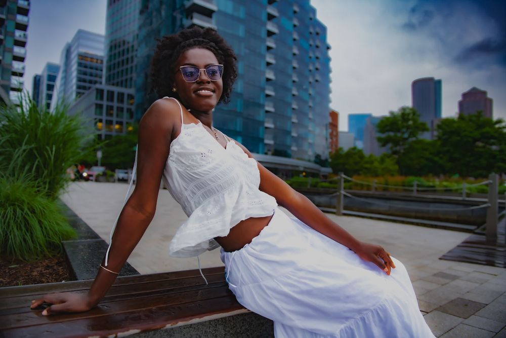 Modern urban portrait with glass buildings and city architecture in the background.