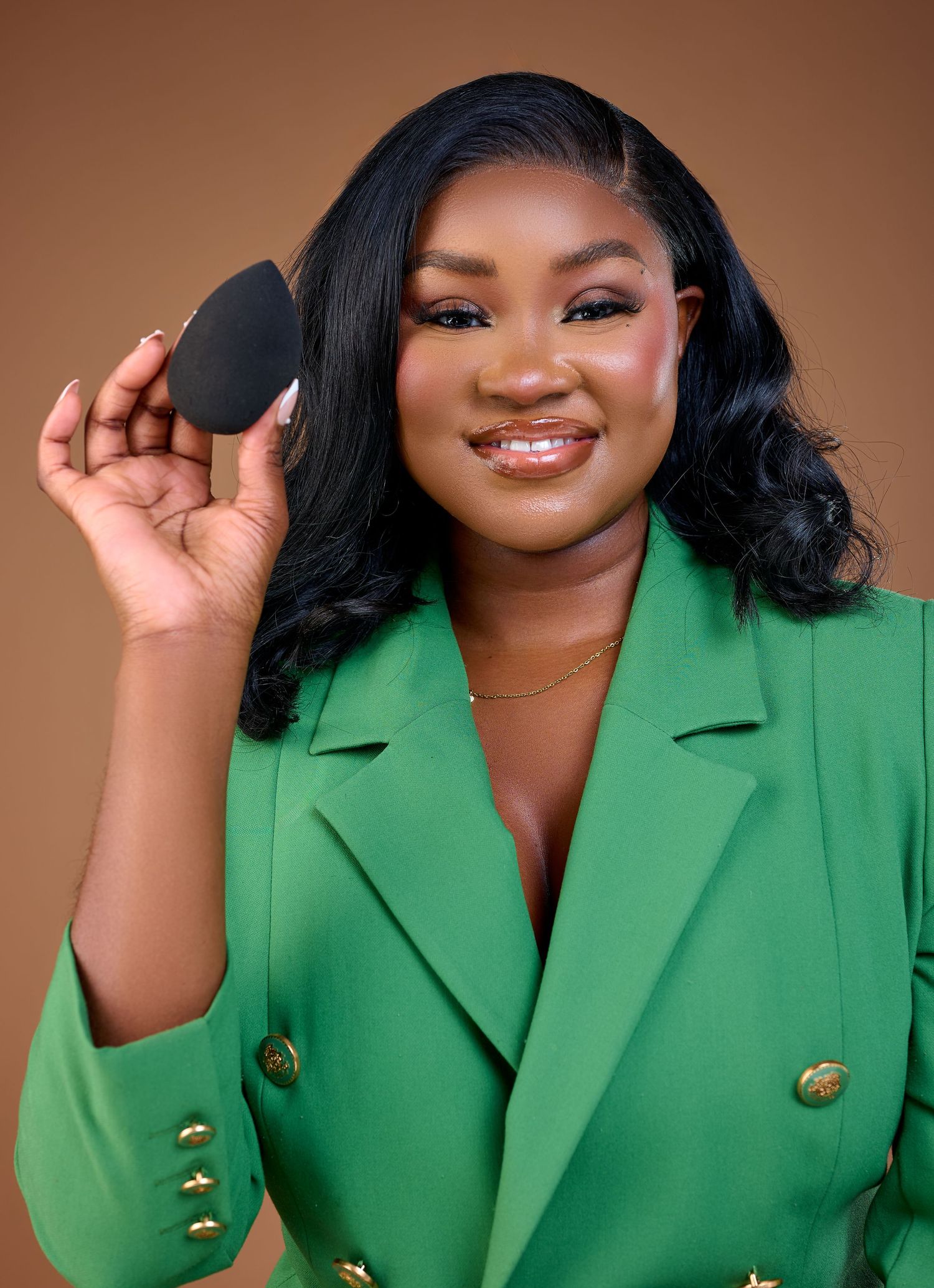a lady holding a makeup sponge