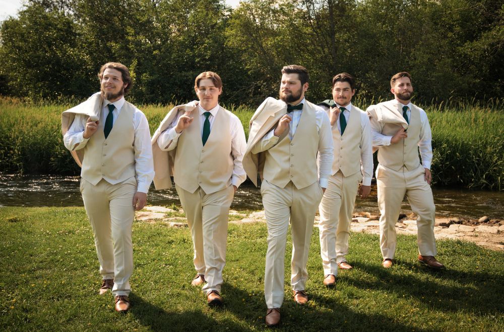 groomsmens with jackets over their shoulders in portrait in spokane washington