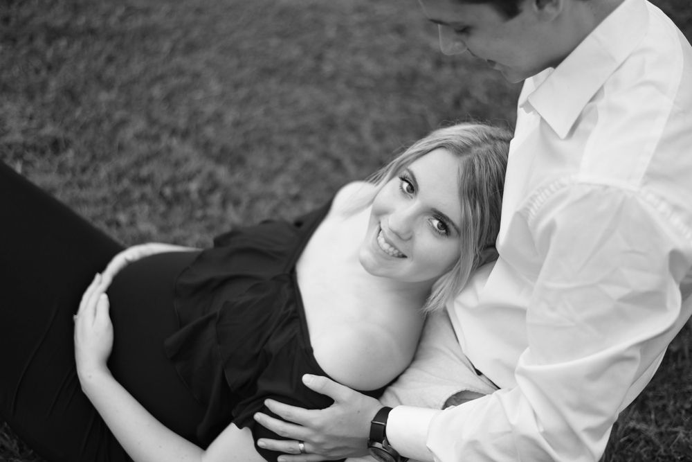 Black and white maternity portraits showing intimate moments between couple.
