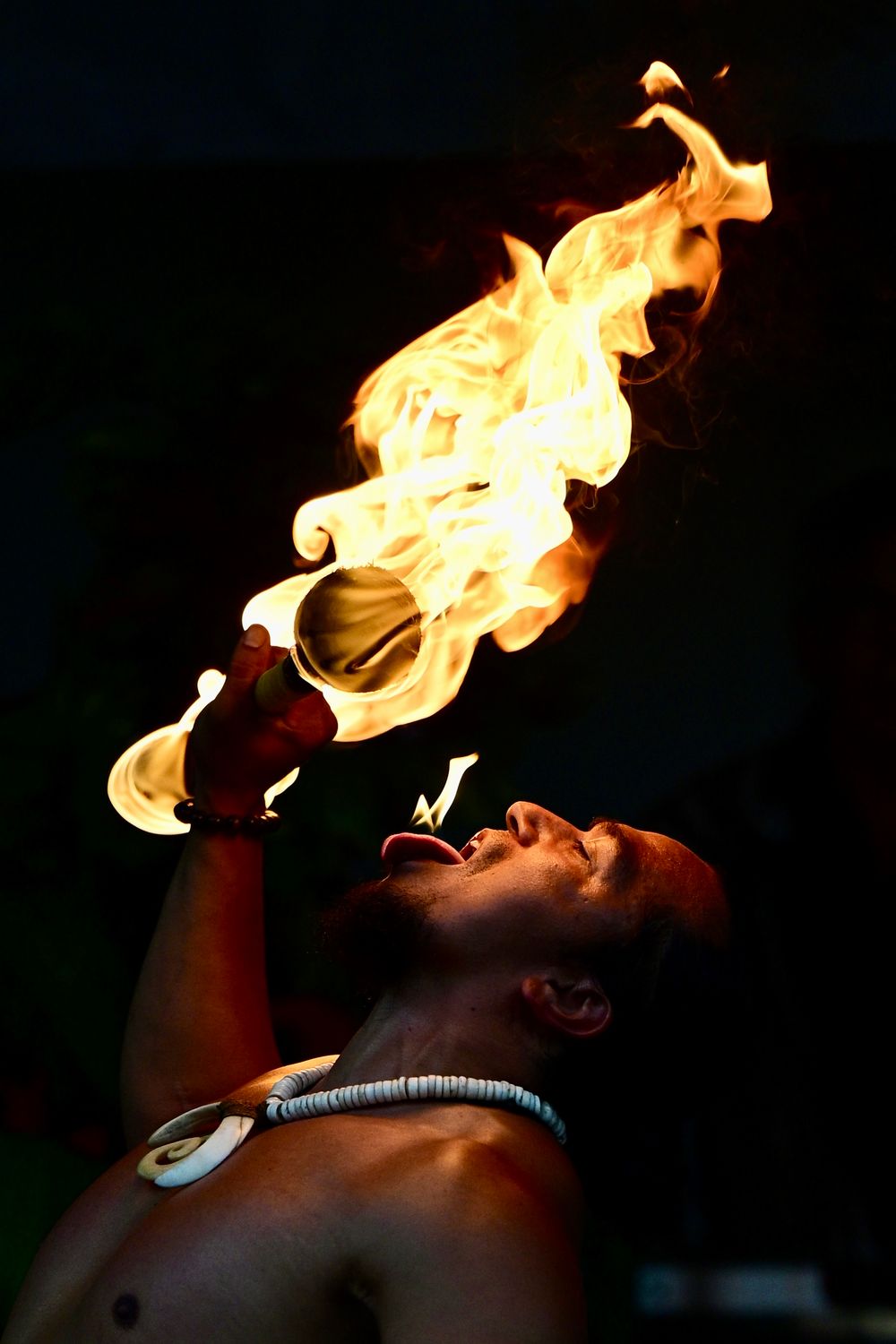 close-up portrait of a fire arts specialist with a dark background