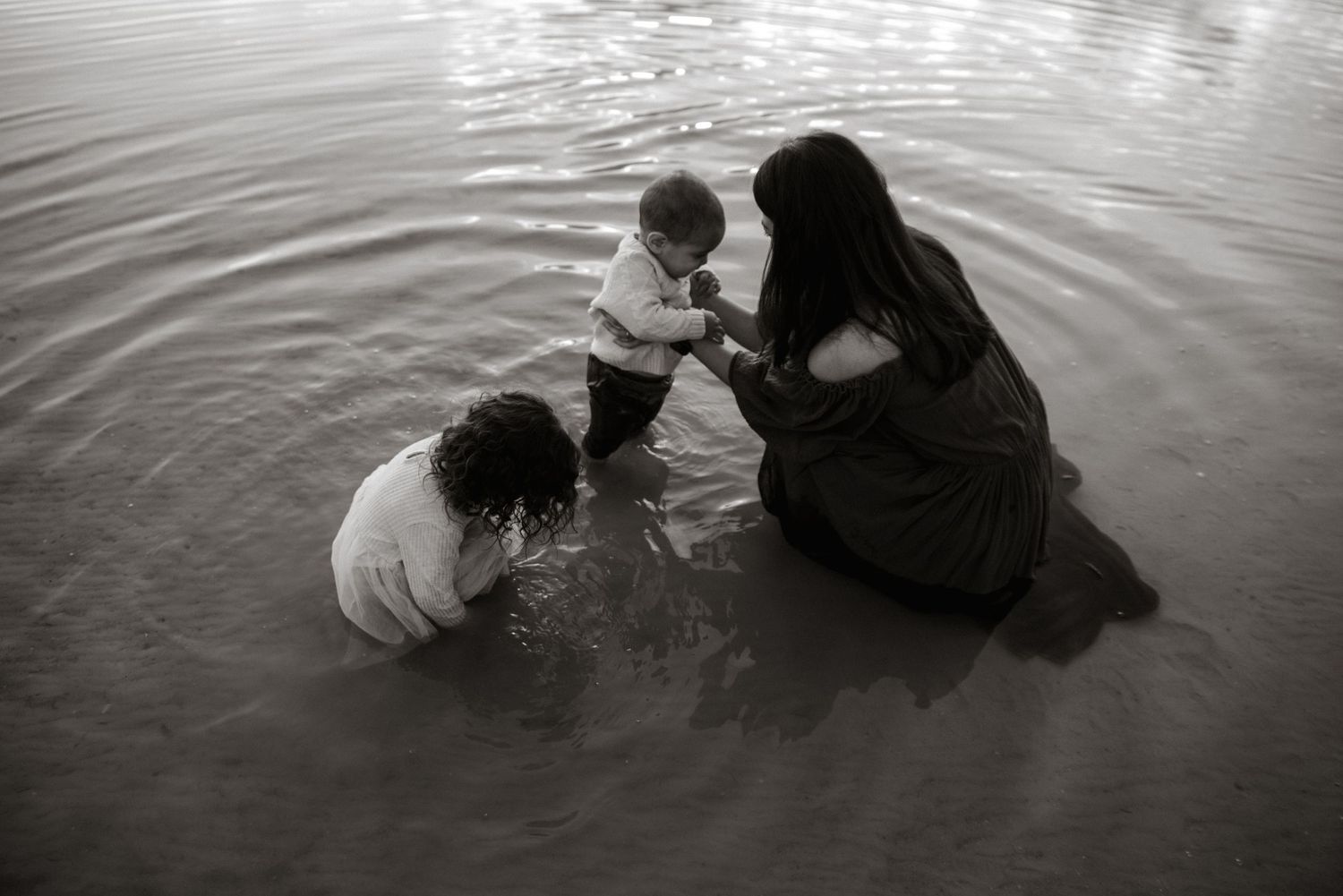 moeder speelt met kinderen in het water