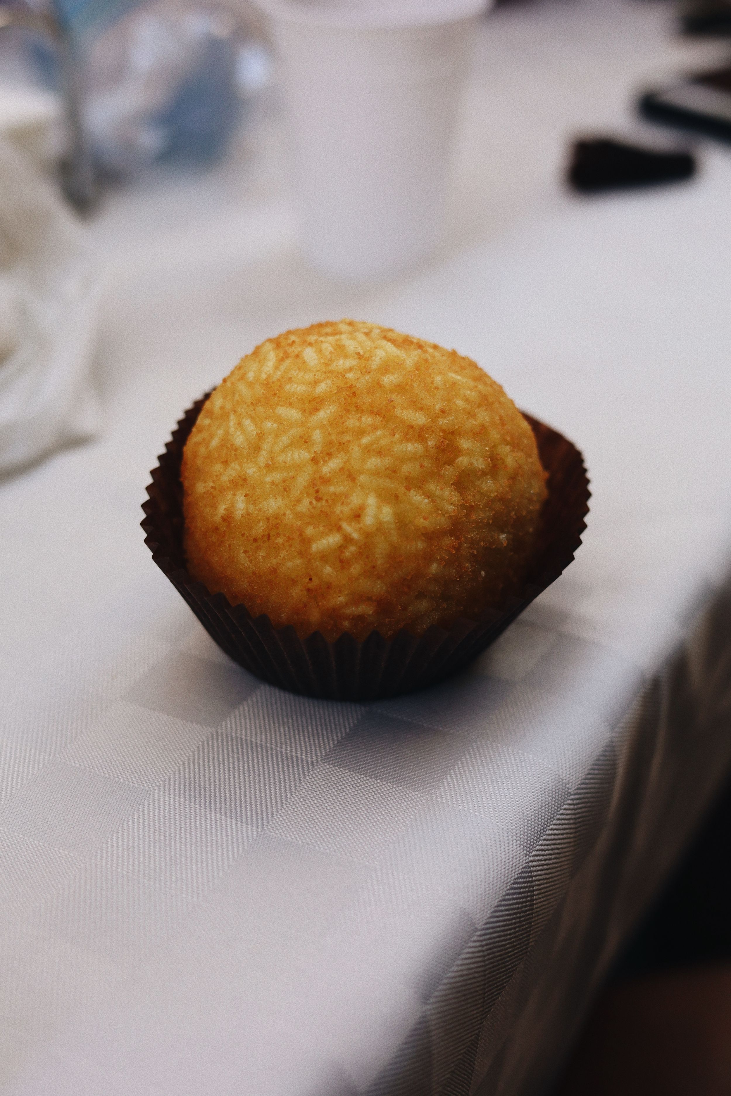 Golden brown madeleines or small cakes served on a crisp white surface.