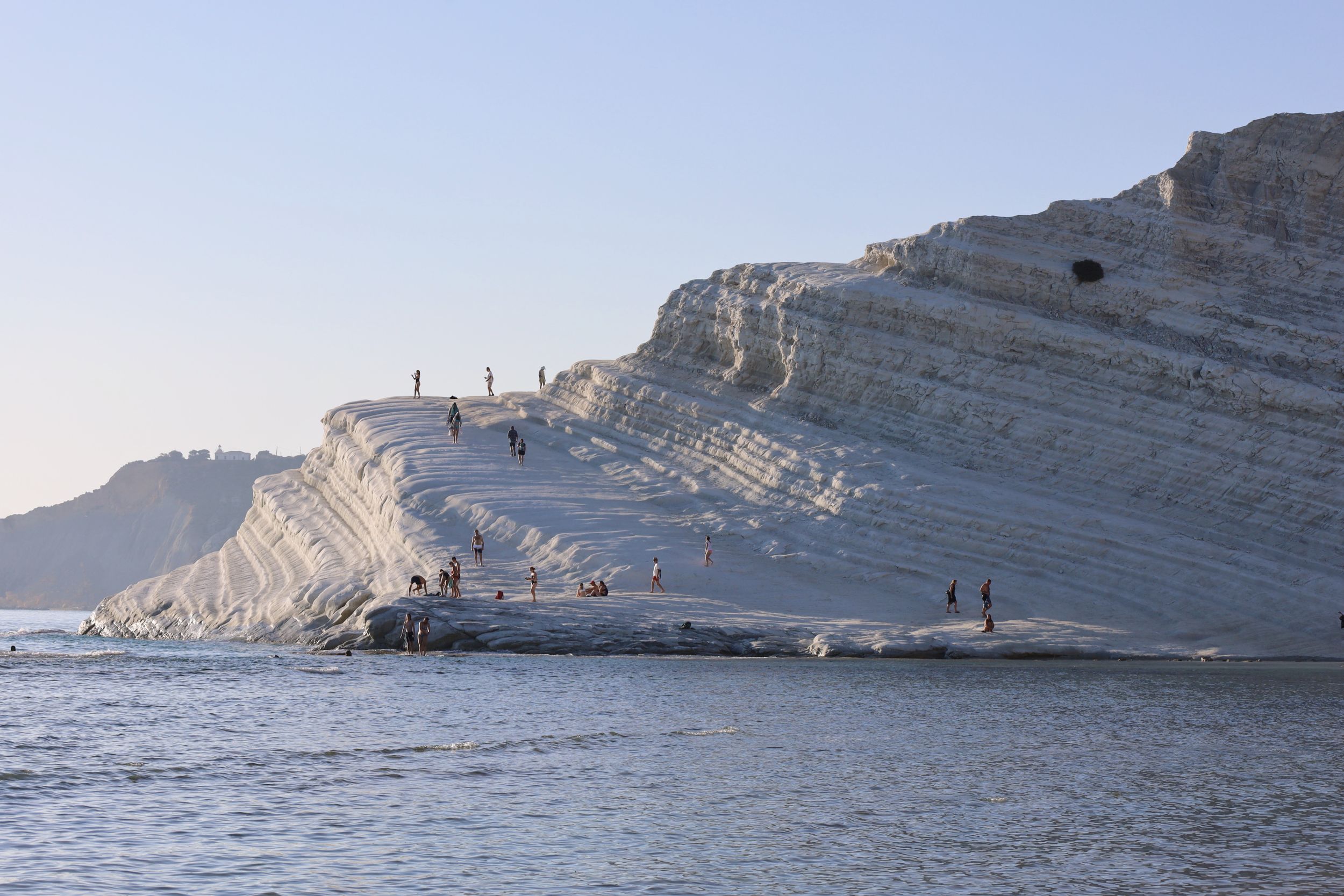 Dramatic white limestone cliffs meeting the Mediterranean Sea along the coastline.