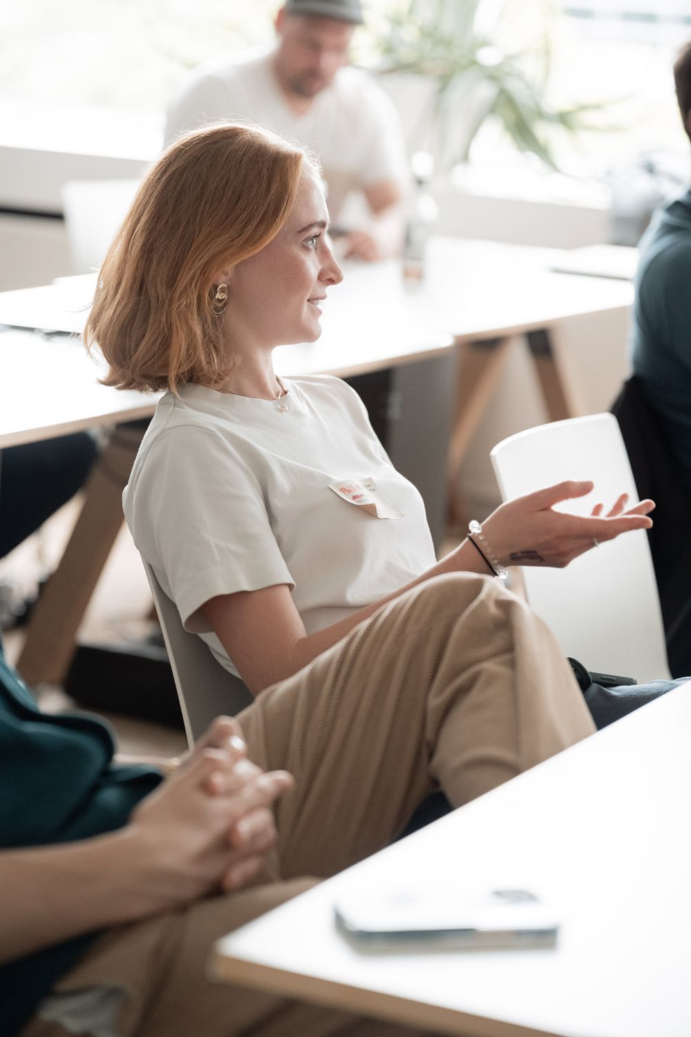 A participant engaging in discussion during a professional workshop or meeting.