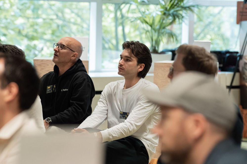 Attentive audience members listening during a business presentation or conference.