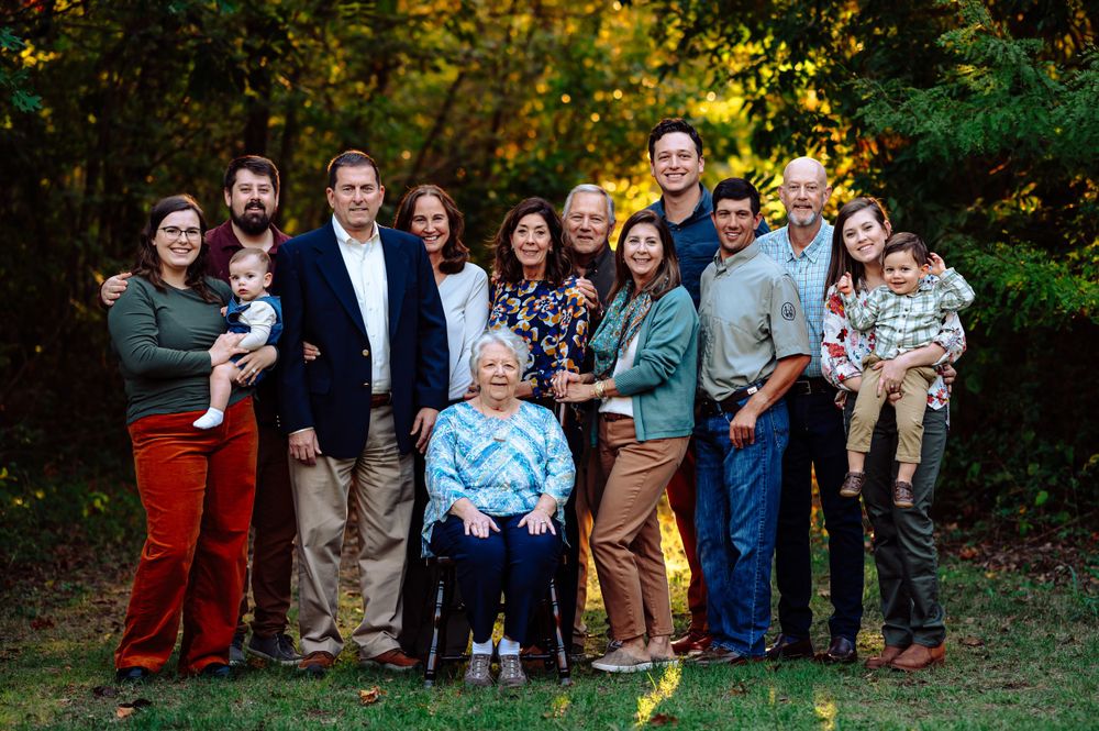 Great grandma and extended family of 14 pose together during dallas area outdoor extended family photo session at sunset
