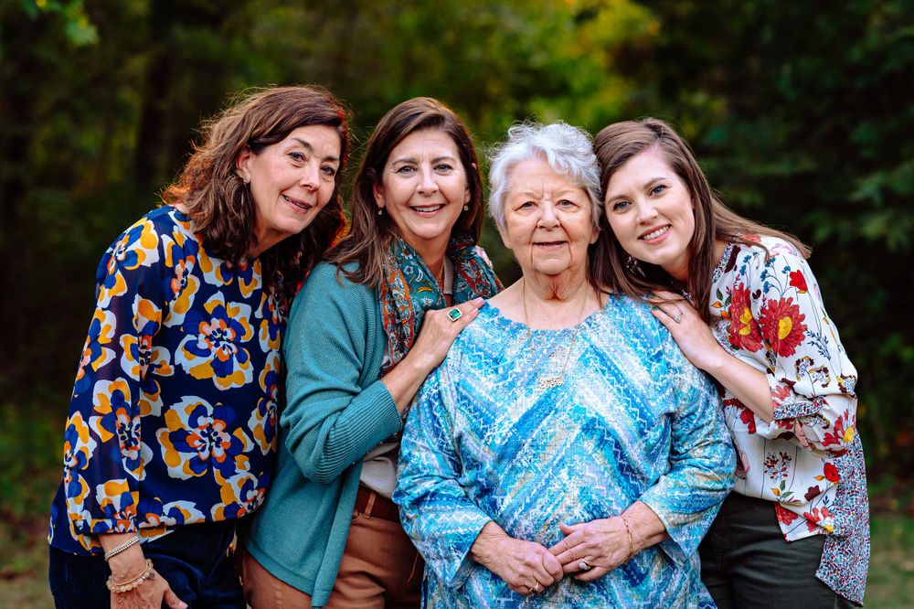 great grandma, daughters, and adult granddaughter hug for dallas area sunset outdoor extended fall family photo session