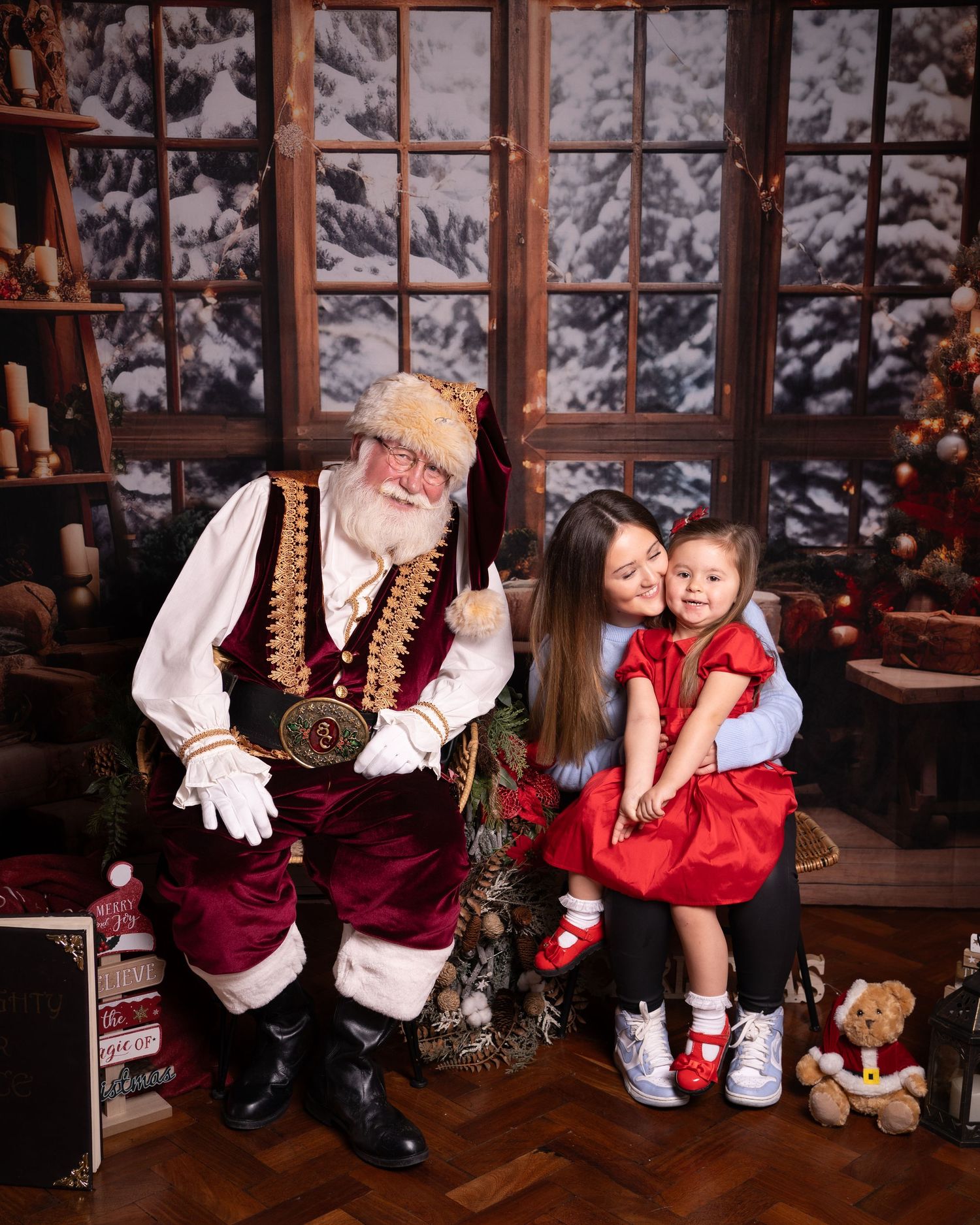 Cozy winter scene in rustic cabin with holiday decorations and snow-covered windows.