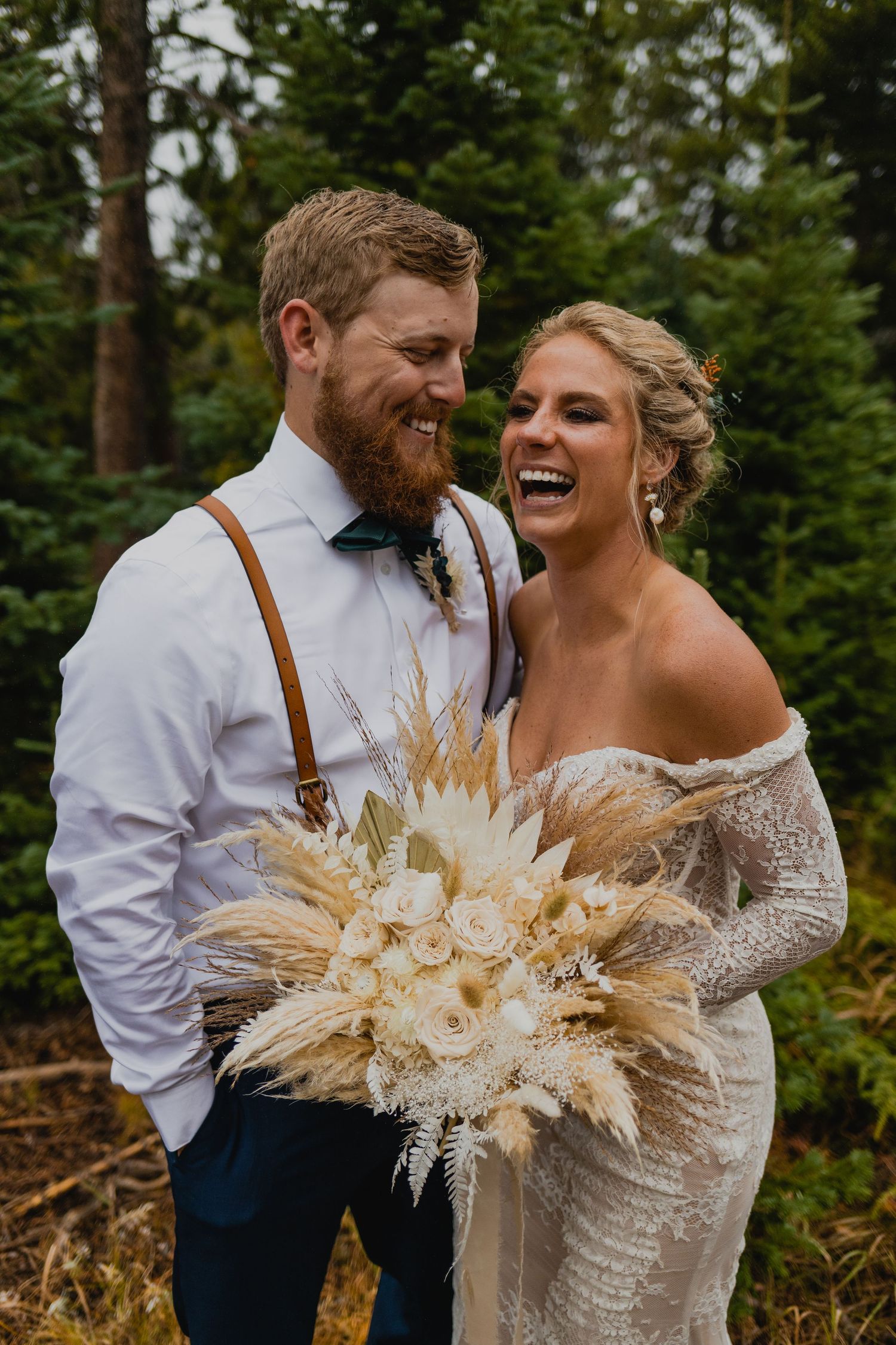 Couple laughing with each other during their Rocky Mountain national Park elopement